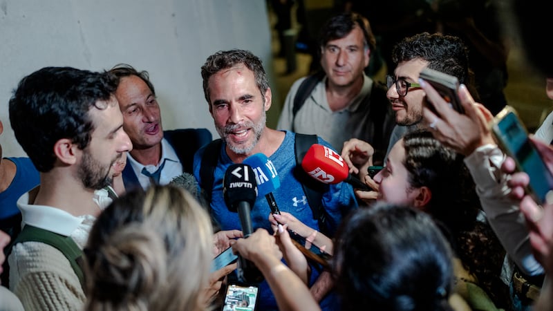 Assaf Regavim, who filmed a video from inside the cabin and helped to overpower the attacker, talks to reporters at Ben Gurion Airport. Getty Images